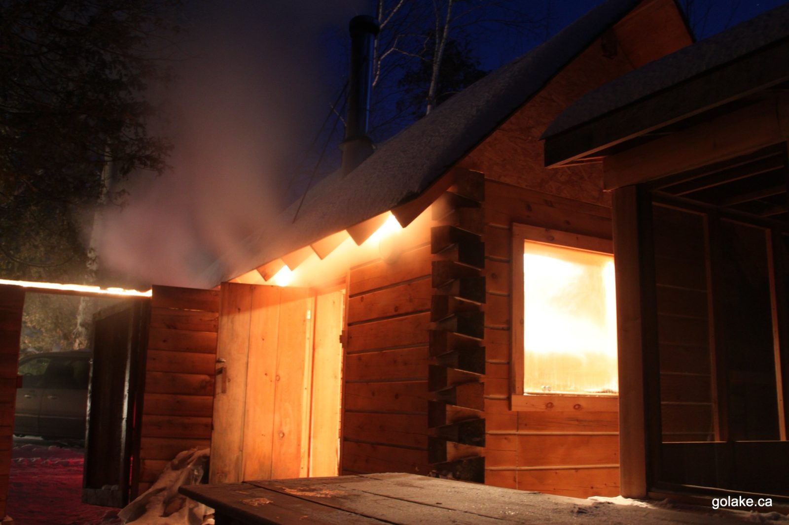 Guest log sauna steaming at night — Goldenville cottage resort, Golden Lake